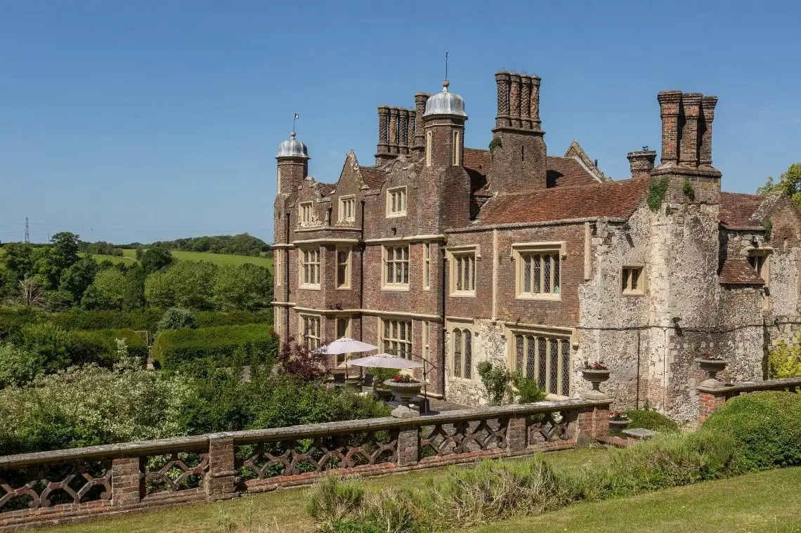 The oldest wing of the house in flint and stone chequerwork beside the brick garden front