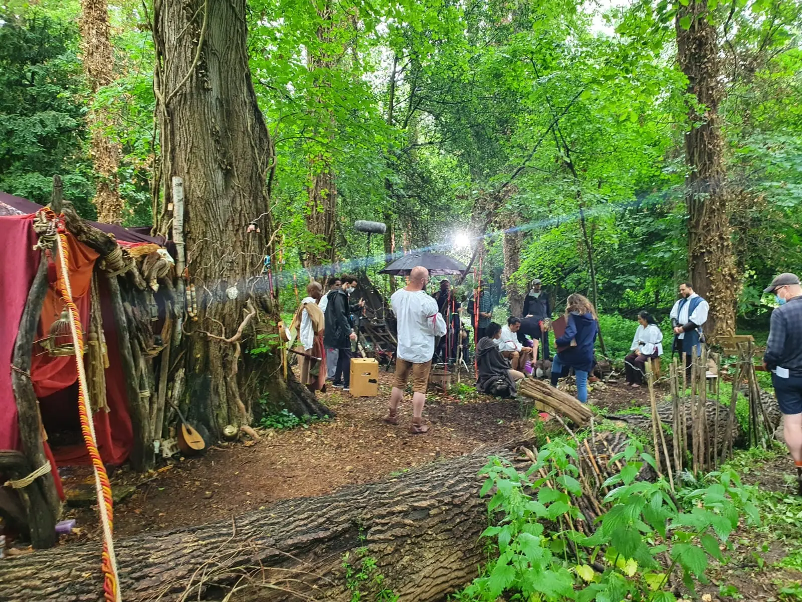 A set built among the trees in the woodland, with crew at work